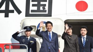Japan's Prime Minister Shinzo Abe (pictured second left) and his wife Akie wave to well-wishers prior to boarding a plane at Tokyo's Haneda Airport on November 17. /AFP