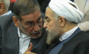 Secretary of Iran's Supreme National Security Council Ali Shamkhani (left) speaks with Iranian President Hassan Rouhani.
