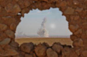 Smoke billows in the background as seen from the position of Syrian Democratic Forces in the village of Abu al-Ilaj on Nov. 7. /AFP