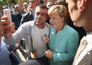 Merkel changes her tune, will pay migrants to leave Germany