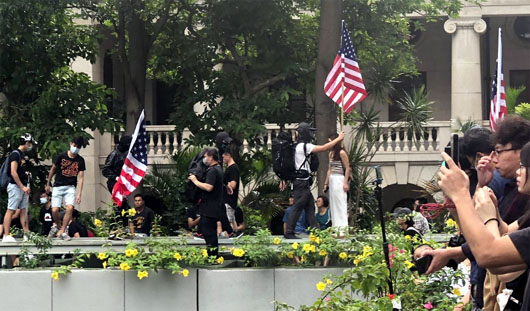 American flag embraced by Hong Kong protesters as U.S. tracks Chinese troop movements