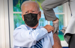 Biden takes Covid booster — on a fake White House set